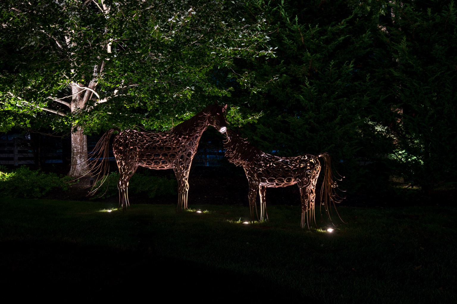 Landscape lighting around horse sculptures